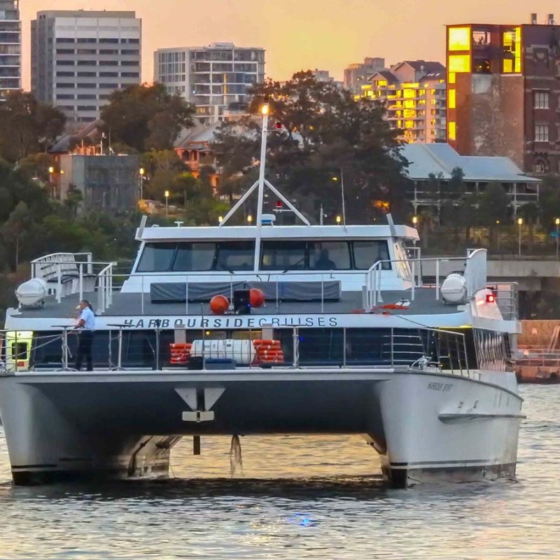 a small boat in a body of water with a city in the background