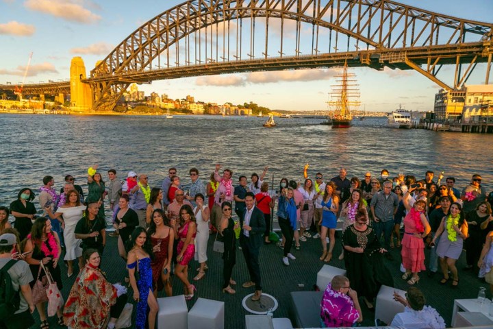 a group of people crossing a bridge over water