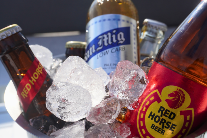 Bottles of beer, including Red Horse, in an ice bucket.