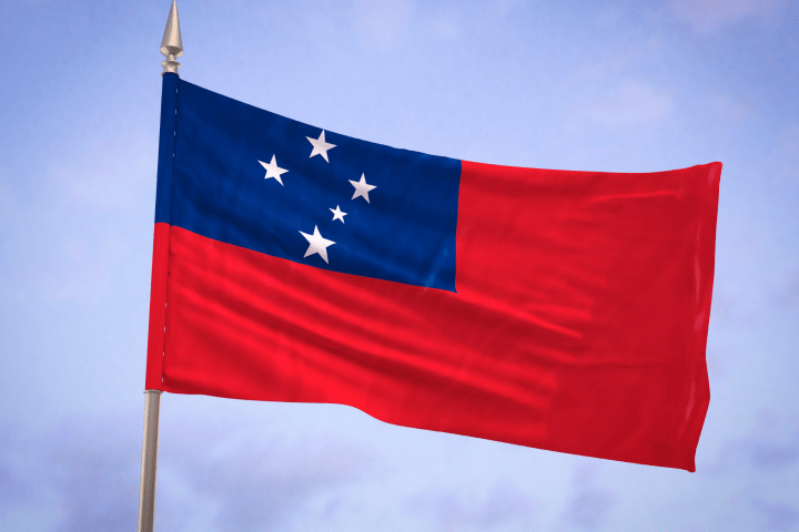 Flag of Samoa with blue canton and white stars on red background.